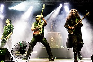 Cradle of Filth in 2018. (L–R): Dani Filth, Marek 'Ashok' Šmerda, Lindsay Schoolcraft (background), and Richard Shaw (Daniel Firth is out of frame).