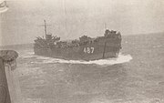 LST-487 pulling up alongside 564 at sea to exchange movies and records. Taken from 564.