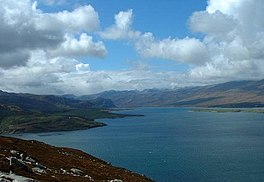 A wide sea loch surrounded by hills