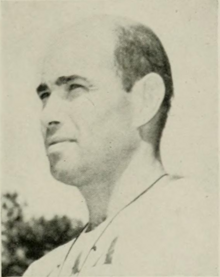 Black and white photograph of a white man, shot from the neck up