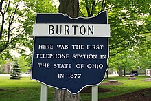 Photo of the historical marker in Burton, Ohio showcasing the first telephone station in Ohio in 1877.