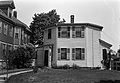 Modest timber frame house with a flat roof. Bevis Tucker House, Chelsea, Massachusetts.