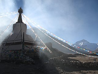 Chorten with prayer flags and the North Face of Mount Everest