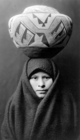 A girl from the Zuni tribe of New Mexico with a painted pottery jar, photographed in c. 1903.