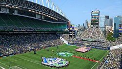 The field and surrounding seats with pre-game pageantry on the field.