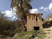 Chaoui building in Menaâ with stone foundation and brick walls visible