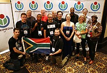 14 people group, 2 ones carrying South Africa flag