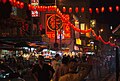 Crowded city street, with red lanterns