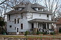 Image 5A wood-frame American Foursquare house in Minnesota with dormer windows on each side and a large front porch