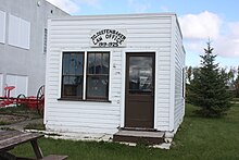 Small wooden shack, painted white, with sign "J.G. Diefenbaker Law Office 1919–1925