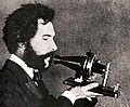 Image 14Actor portraying Alexander Graham Bell in a 1932 silent film. Shows Bell's second telephone transmitter (microphone), invented 1876 and first displayed at the Centennial Exposition, Philadelphia. (from History of the telephone)