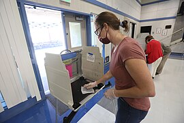 A poll worker sanitizes an election booth in California.