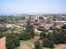 aerial view of highrise building and low rise red roofed buildings