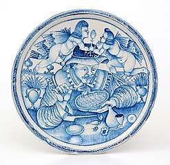 Plat peint d'un "Mangeur de macaronis", majolique de Laterza, dernier quart du XVIIe siècle.