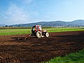 A tractor pulling a chisel plow in Slovenia