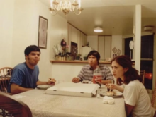 A photo of band members Roby, Viet and Val eating pizza.