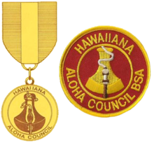 the badge is a round red patch with a gold border; the outer edge has the text Hawaiiana and Aloha Council; the inner circle has the image of a poi pounding stone with a flaming torch in front; the medal uses the same image as the badge suspended from a red and gold ribbon