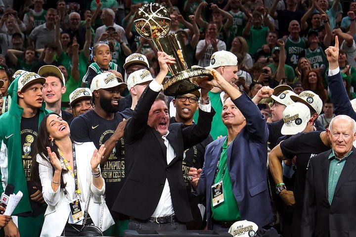Wyc Grousbeck hoisted the NBA championship trophy in June with the help of Steve Pagliuca (right).