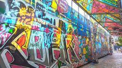 Bright and dramatic wall art fills Graffiti Alley in Central Square.