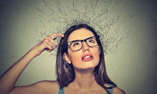 Closeup portrait young woman scratching head, thinking daydreaming with brain melting into lines question marks looking up isola