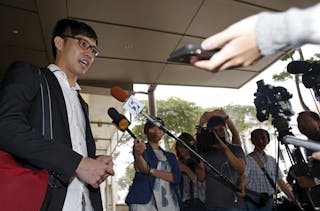 Blogger Roy Ngerng speaks to the media after attending a damages hearing in a defamation case by Singapore's Prime Minister Lee 