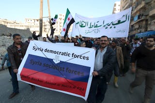 People attend a protest against forces loyal to Syria's President Assad, Russia and the Syrian Democratic forces, in Tariq al-Ba