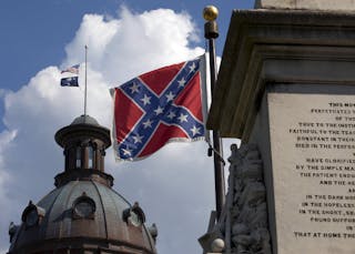 The U.S. flag and South Carolina state flag flies at half staff to honor the nine people killed in the Charleston murders as the