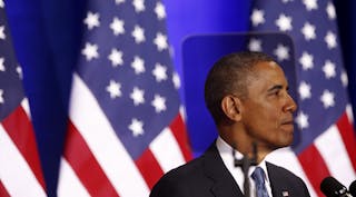 U.S. President Barack Obama is seen through a teleprompter as he speaks about the National Security Agency from the Justice Depa