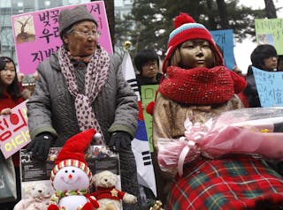 Former South Korean comfort woman Gil Won-og looks at the "Peace Monument", representing Korean comfort women, in Seoul