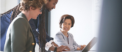 A group of people working together on a laptop.