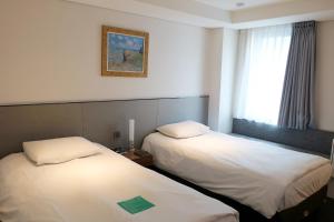 Ένα ή περισσότερα κρεβάτια σε δωμάτιο στο Hotel Thomas Myeongdong
