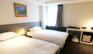 Ένα ή περισσότερα κρεβάτια σε δωμάτιο στο Hotel Thomas Myeongdong