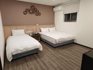 Katil atau katil-katil dalam bilik di Aimei Hotel City Main Building