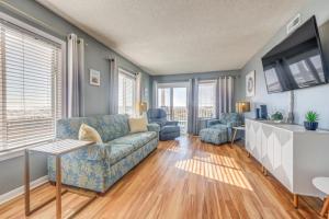 a living room with a couch and two chairs at The Beach Is Back in Myrtle Beach