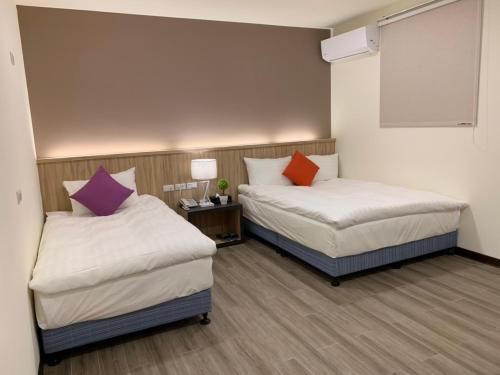 Katil atau katil-katil dalam bilik di Aimei Hotel City Main Building