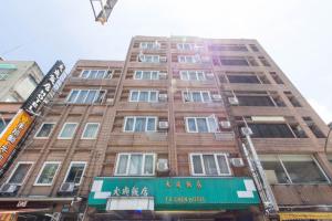 a tall brick building with a sign on it at Day Chen Hotel in Yilan City