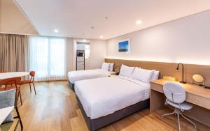 Ένα ή περισσότερα κρεβάτια σε δωμάτιο στο New Seoul Hotel Myeongdong