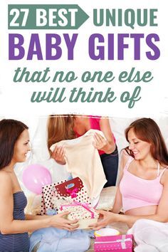 two women are sitting on the floor with presents and one is holding a baby's shirt