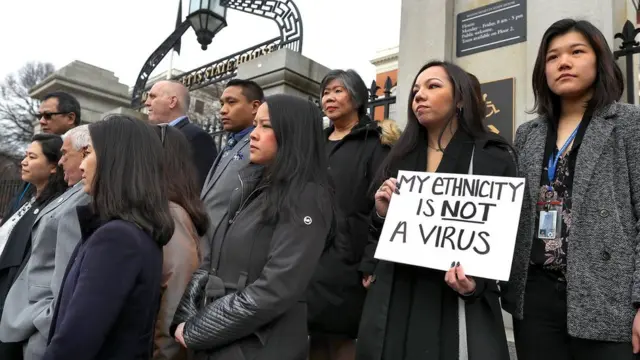 Members of the Asian American Commission hold a press conference on the steps of the Massachusetts State House to condemn racism towards the Asian American community because of coronavirus on March 12, 2020 in Boston