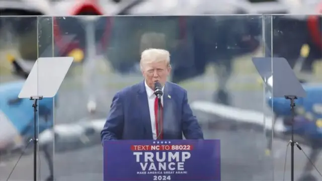 Trump appeared behind bullet-proof glass at this later rally in August