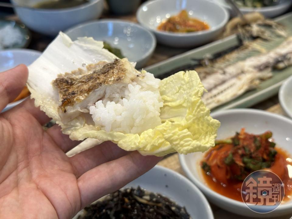 用生菜包著米飯和魚肉一口吃，風味清爽許多。