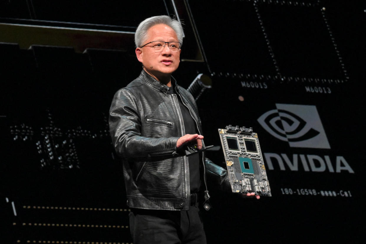 Nvidia CEO Jensen Huang stands onstage at a computer expo.
