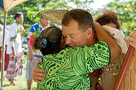 US Navy 090708-N-9689V-006 A woman hugs Capt. John Shaub, deputy mission commander of Pacific Partnership 2009, during a ribbon cutting ceremony celebrating the renovation of the assembly hall.jpg