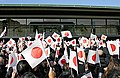 Emperor Akihito prepares to greet the crowd on his birthday in Tokyo