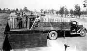 Thumbnail for File:Loading bombs onto the back of a truck at Columboola Ammunition Depot, Queensland, circa 1943.jpg