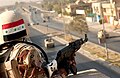 An Iraqi soldier guards on a building armed with an AK-47.