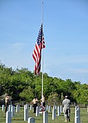 US Navy 100531-N-8241M-135 Sailors, Marines and Soldiers assigned to Naval Station Guantanamo Bay, observe morning colors at the Cuzco Wells Cemetery on the base as an observance of Memorial Day.jpg