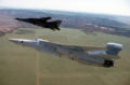 EF-111A (foreground) and F-111F (background) in flight.