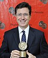 Colbert in May 2012, holding his Peabody Award