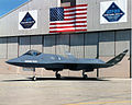 Northrop-McDonnell Douglas YF-23 on side of hangar.